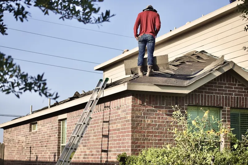 Professional roofer working on a residential roof in Waterman Meadows